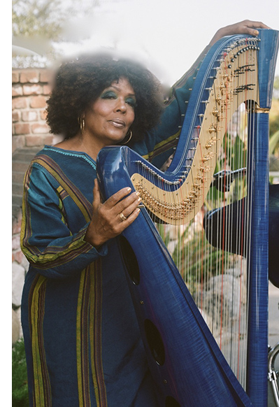 Radha standing by blue harp